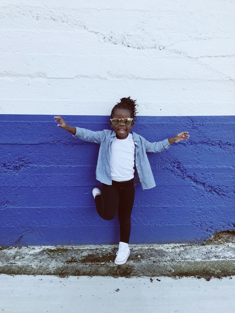 Young child mid-jump with arms outstretched