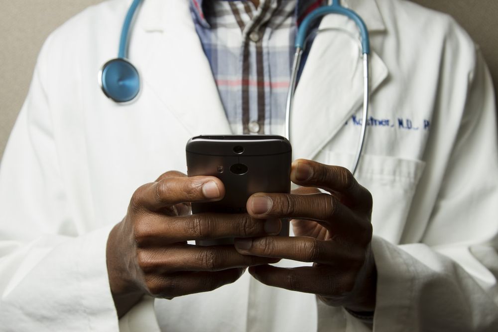 Physician reviewing case notes and reference materials